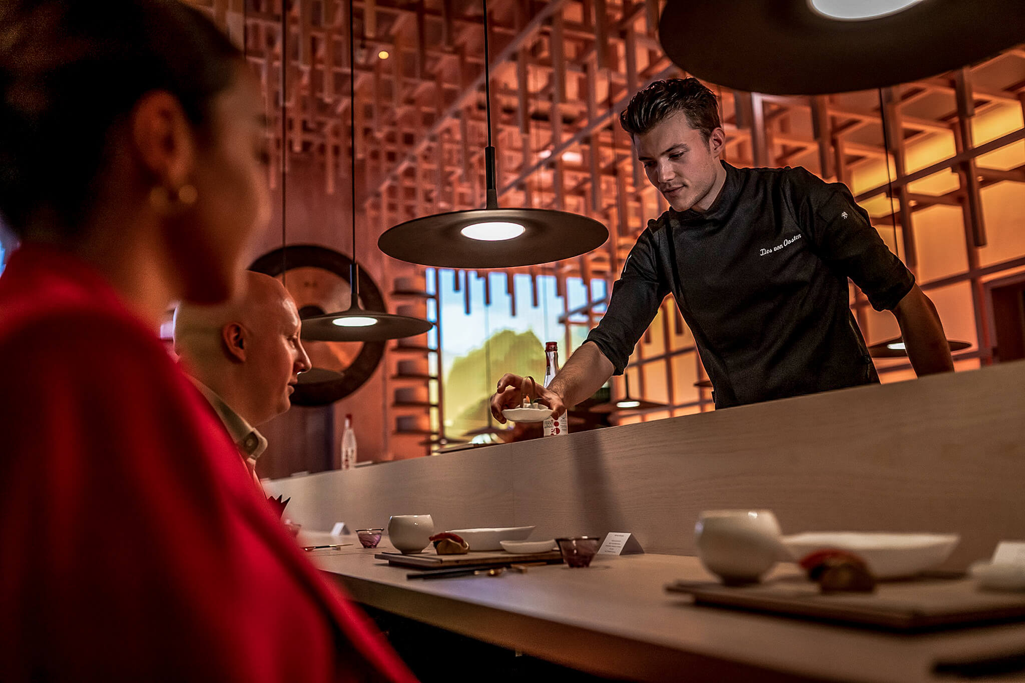 Eatrenalin waiter serving guests an eight-course menu for all senses