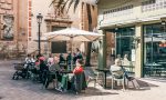Customers sitting in the outdoor dining area of the restaurant Doña Petrona in Valencia.