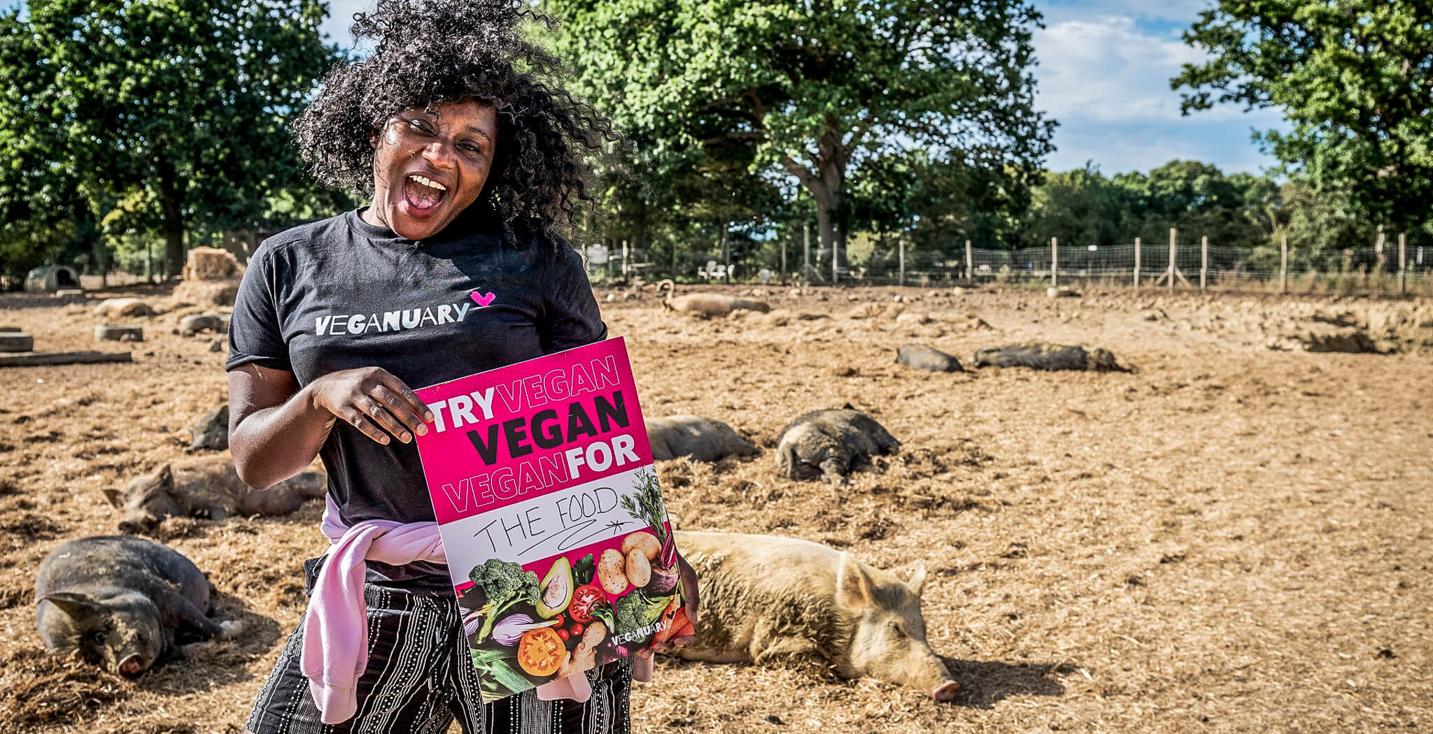 Black woman with poster that promotes a vegan diet in January (Veganuary)